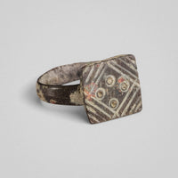 Angled bezel view of medieval bronze ring Radvan with hatched triangular fields and patina