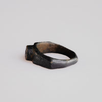 Angled side view of Roman bronze ring Numerius with integral cast bezel