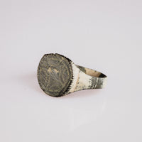 Angled study of medieval bronze ring Vitalya showing engraved bezel and hoop taper