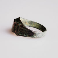 Angled view of Byzantine bronze ring Aetheria showing bezel platform and shoulder descent