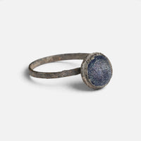 Byzantine bronze ring 'Kaloira' shows its blue setting and narrow hoop at an angle.