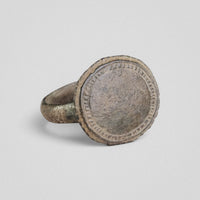 Angled view of Byzantine bronze ring Xenaros showing bezel projection from narrow hoop