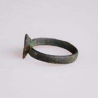 Angled view of Byzantine bronze ring Zosimos showing applied square bezel construction
