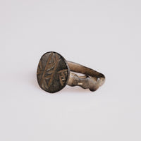 Angled view of Byzantine bronze signet Theodulos with herringbone engraving detail