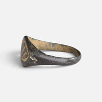 Medieval bronze ring 'Aldhelm' shows its bezel edge and tapering hoop from the side.
