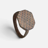 Medieval bronze ring 'Anselm' shows its cross-hatched octagonal bezel and full hoop from another angle.