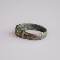 Angled view of medieval bronze ring Radenko highlighting shoulder cross pattée.