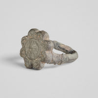 Angled view of medieval bronze ring Rosalind showing rosette bezel and hoop detail