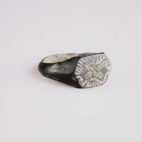 Angled view of medieval silver ring Radomir showing hexagonal bezel and tapering hoop