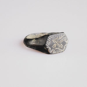 Angled view of medieval silver ring Radomir showing hexagonal bezel and tapering hoop