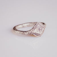 Angled view of medieval silver ring Ruslan showing ribbed shoulder decoration and worn bezel motif