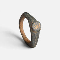 Roman bronze ring 'Aquilarius' shows its worn circular bezel and pointed shoulder from another angle.
