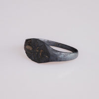 Angled view of Roman bronze ring Formica highlighting ant engraving and shoulder wear