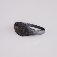 Angled view of Roman bronze ring Formica highlighting ant intaglio and shoulder wear