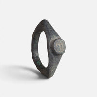 Roman bronze ring 'Hesperia' shows its circular bezel face and pointed shoulders from another angle.