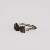 Angled view of Roman bronze ring Numerius with malachite green and tenorite patina