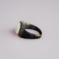 Angled view of Roman bronze ring Numerius with visible malachite and tenorite patina