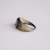 Angled view of Roman bronze ring Volusia showing integral bezel and tapered shoulders