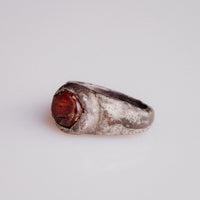 Angled view of Roman silver ring Pisculus with fish intaglio in raised bezel