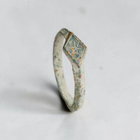 Angled view of Stellira medieval bronze ring showing shoulders and lozenge bezel with star motif