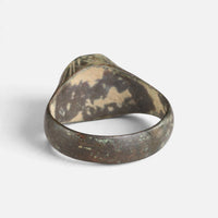 Medieval bronze ring 'Radwina' shows the plain back of its setting and the broad inner hoop.