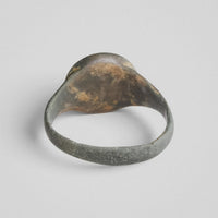 Back view of medieval bronze ring Lioris showing patinated underside of bezel
