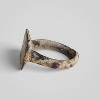 Back view of medieval bronze ring Radvan revealing burial deposits inside the hoop