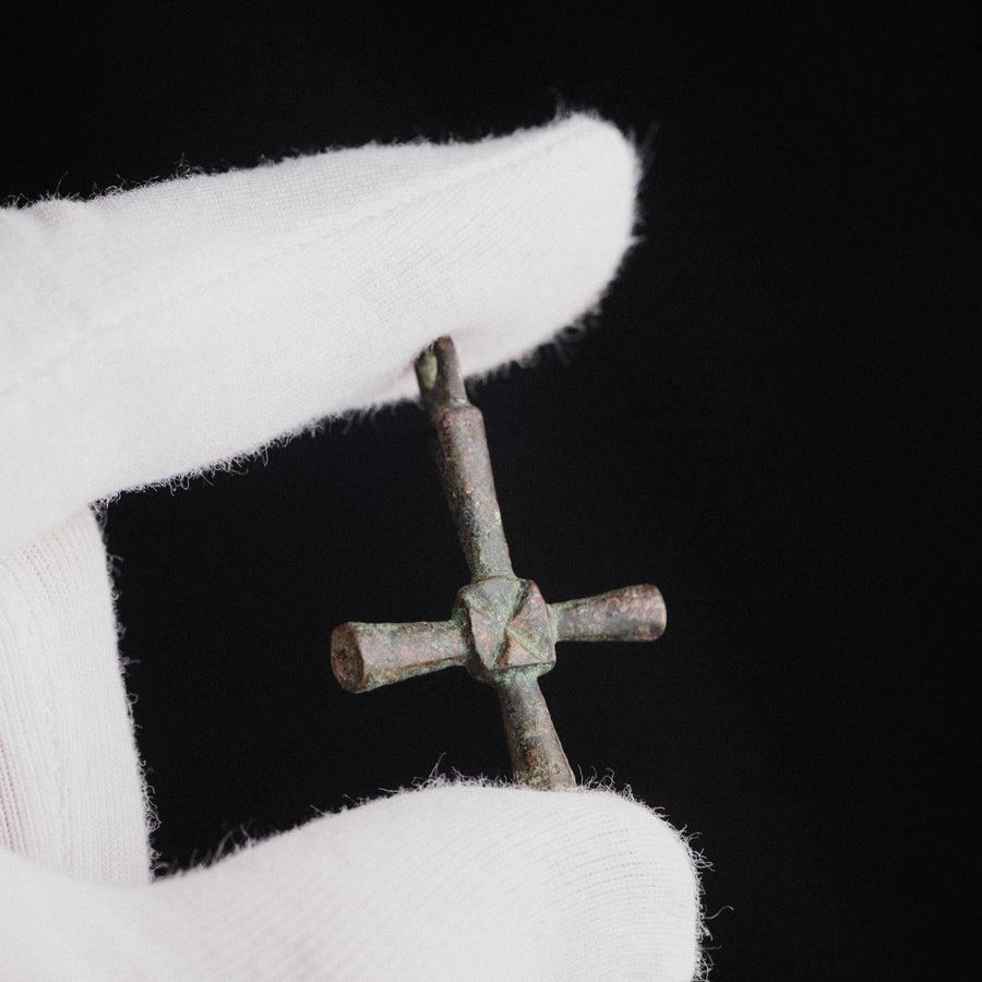 Byzantine bronze cross pendant Chariton held in a gloved hand for scale, showing devotional pectoral size