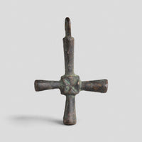 Byzantine bronze cross pendant Chariton in profile, showing cylindrical arm terminals and cast loop