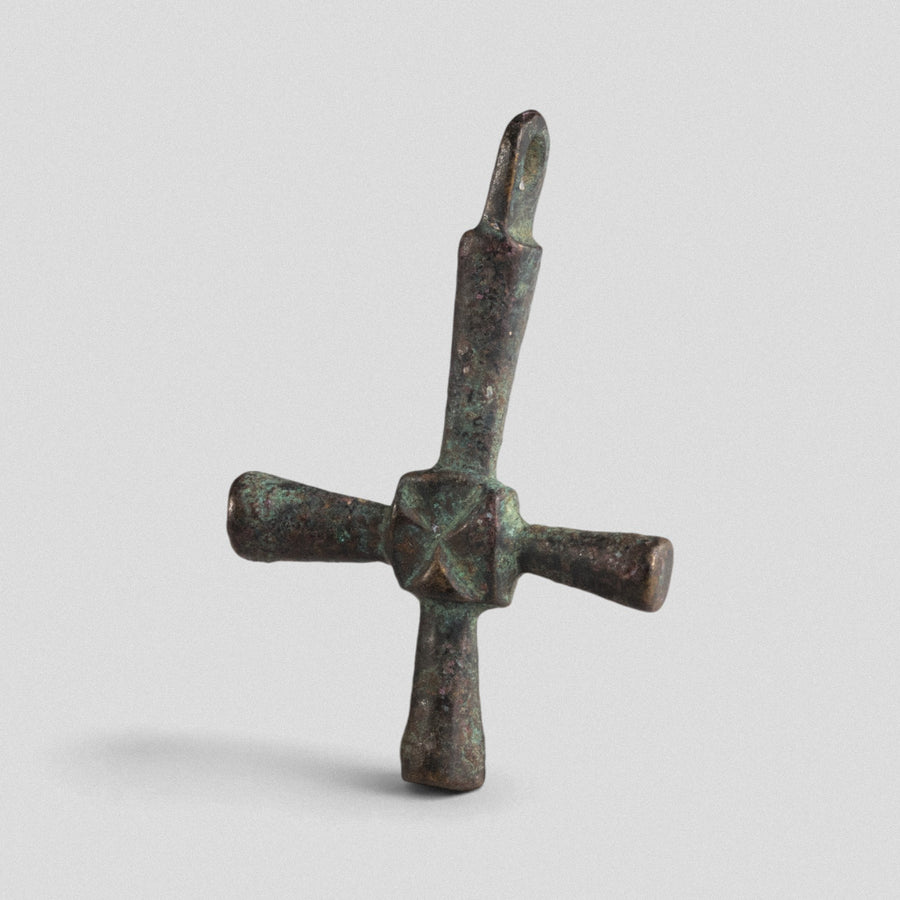 Byzantine bronze cross pendant Chariton, three-quarter view highlighting thickened square junction and saltire mark