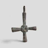 Byzantine bronze cross pendant Chariton with cylindrical arms and incised saltire at central hub, front view