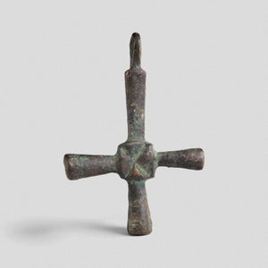 Byzantine bronze cross pendant Chariton with cylindrical arms and incised saltire at central hub, front view