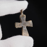Byzantine bronze cross pendant Phanourios held in gloved hand, showing scale and punched decoration
