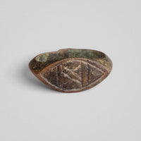 Byzantine bronze ring Doukas lying flat, bezel face displaying three vertical panels