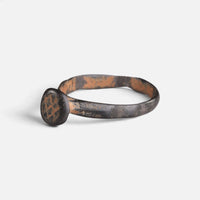 Byzantine bronze ring 'Georgios' shows its engraved circular bezel from the opposite front angle.