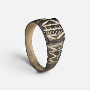 Byzantine bronze ring 'Ioanna' shows its geometric bezel and decorated broad shoulder at an angle.