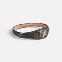Byzantine bronze ring 'Isidoros' shows its incised bezel mark and narrow shoulder at an angle.