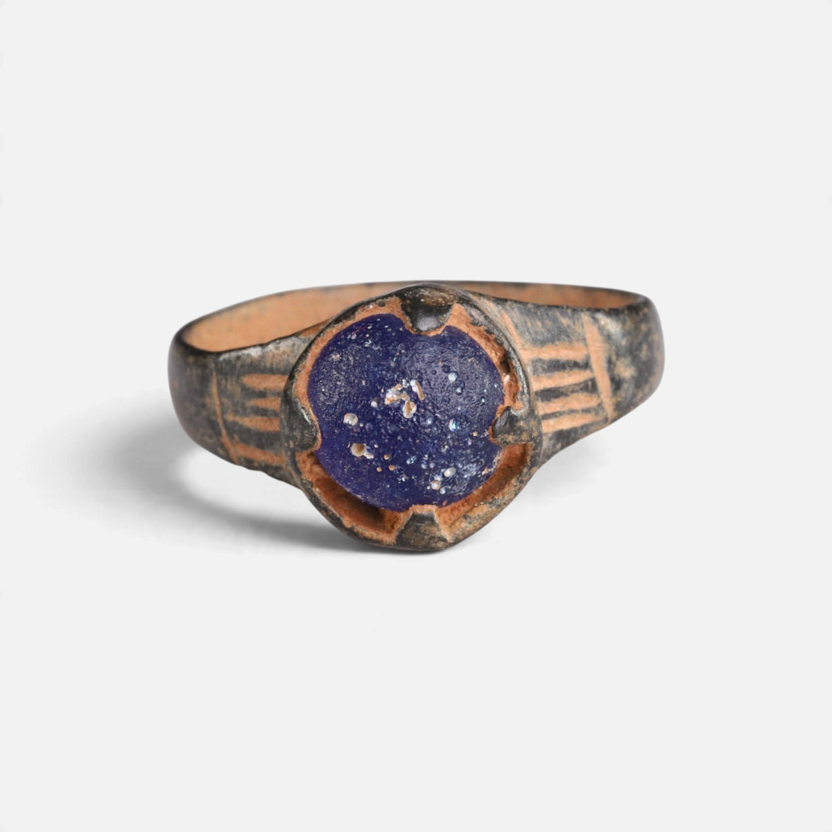 Byzantine bronze ring 'Kallinike' shows its blue setting and incised shoulder grooves from the front.