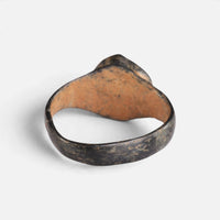 Byzantine bronze ring 'Kallinike' shows the plain back of its raised setting and the inner hoop.