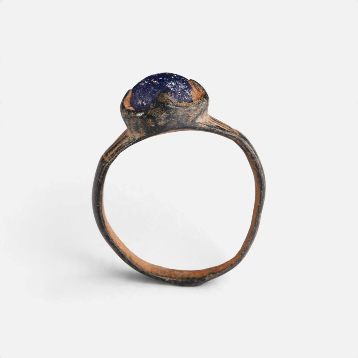 Byzantine bronze ring 'Kallinike' shows its raised blue setting above the complete hoop in profile.