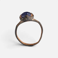 Byzantine bronze ring 'Kallinike' shows its raised blue setting above the complete hoop in profile.