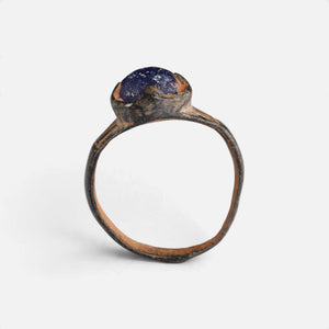 Byzantine bronze ring 'Kallinike' shows its raised blue setting above the complete hoop in profile.