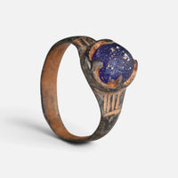 Byzantine bronze ring 'Kallinike' shows its blue setting and grooved broad shoulder above the full hoop.