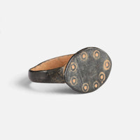 Byzantine bronze ring 'Okellina' shows its ring-and-dot bezel decoration and broad shoulder at an angle.