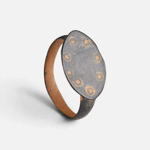 Byzantine bronze ring 'Okellina' shows its ring-and-dot bezel border and complete hoop at an angle.