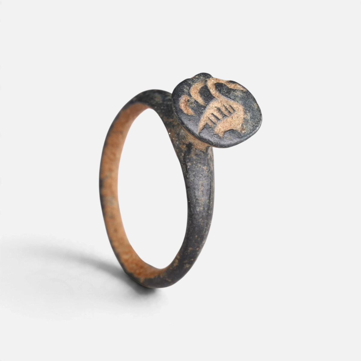 Byzantine bronze ring 'Peristerios' shows its curved bezel device and full hoop at an angle.
