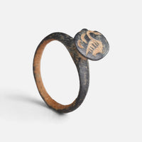 Byzantine bronze ring 'Peristerios' shows its circular bezel device and complete hoop at an angle.