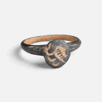 Byzantine bronze ring 'Peristerios' shows the curved device on its circular bezel from the front.