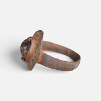 Byzantine bronze ring 'Porphyra' shows its raised purple setting and narrow hoop from the opposite side.
