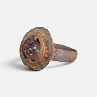 Byzantine bronze ring 'Porphyra' shows its purple setting and dotted border from the opposite front angle.